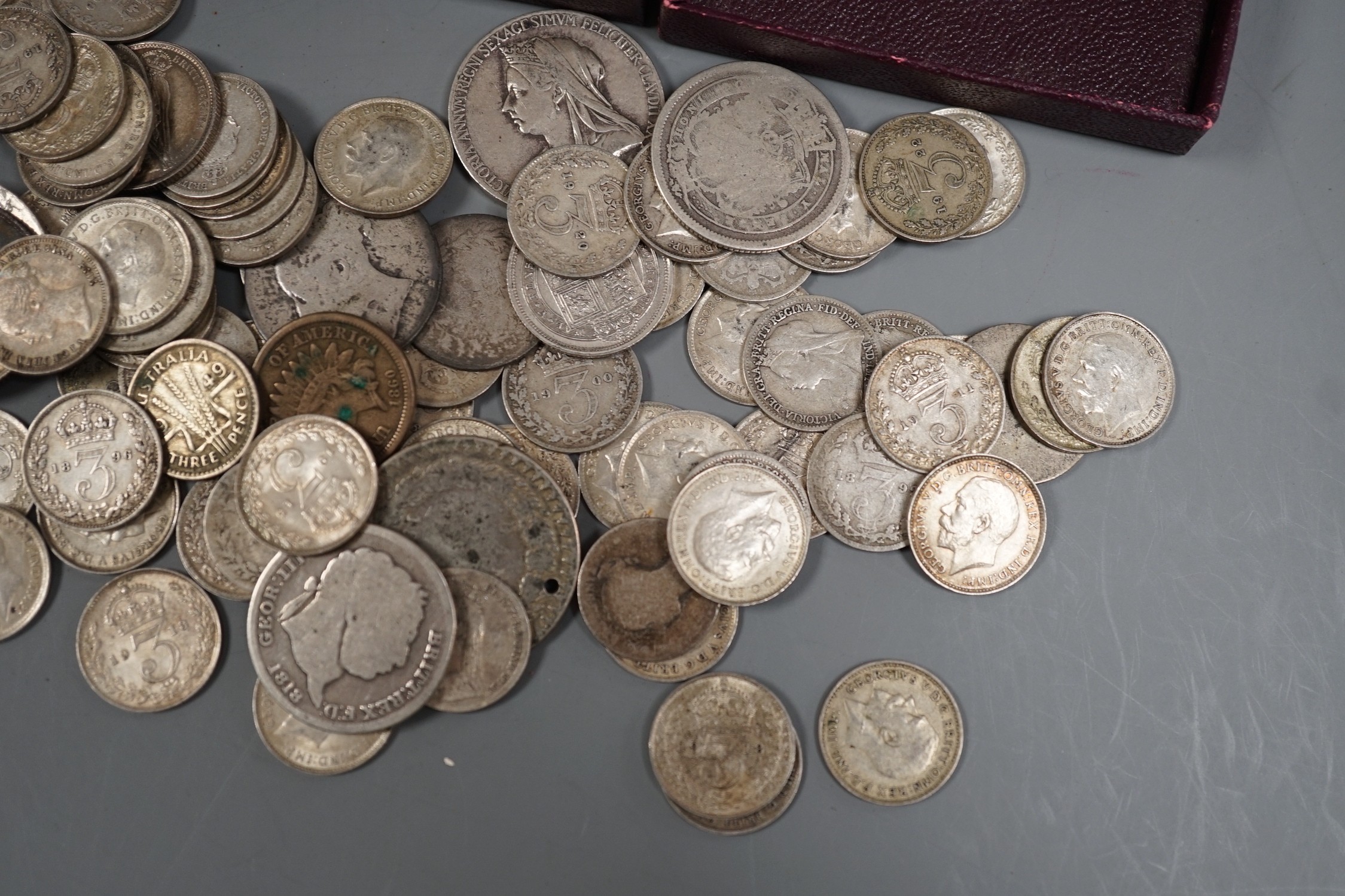 A collection of silver threepences and minor coins